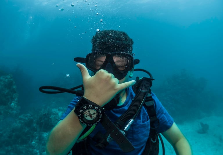 a man in a scuba suit and scuba goggles in the water