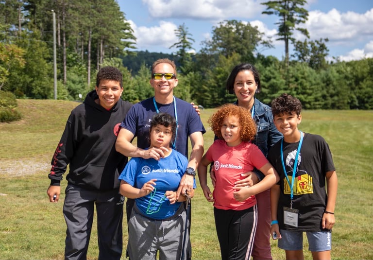 a family posing for a picture in a field