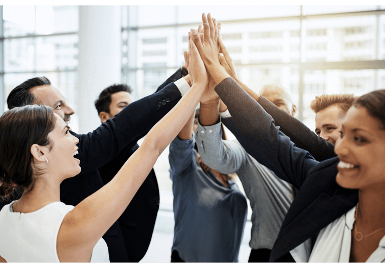 Team members high-fiving after completing a business milestone