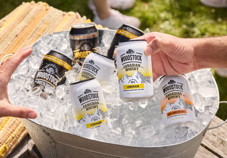 Product campaign photography - a person holding a woodstock can in a bucket of ice