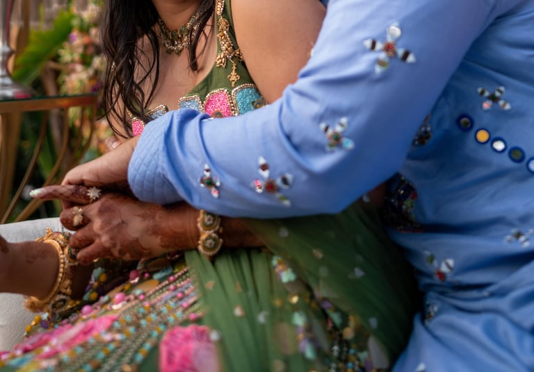 a man and woman in a colorful dress and a man in a blue suit