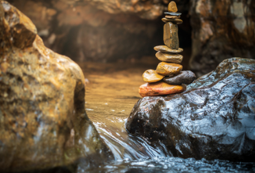 Balancing rocks outside monastery, a symbol of the balance cultivated to create the life you desire.