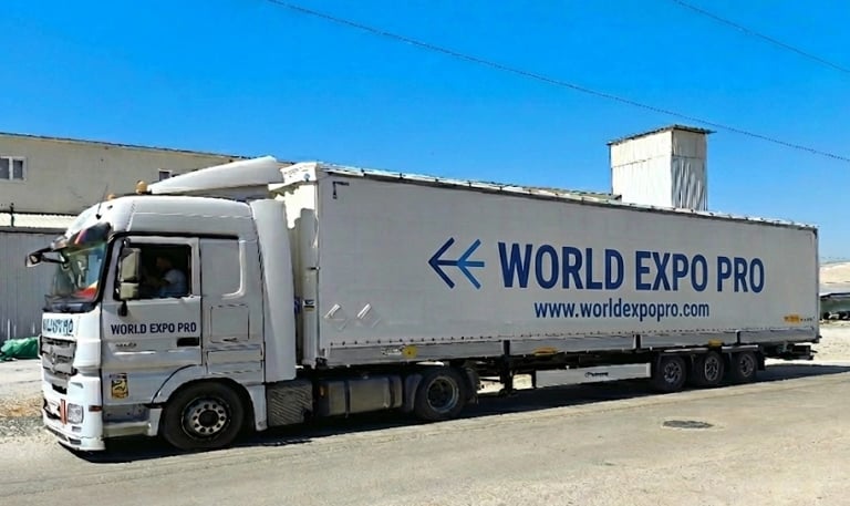 a truck with a world of expo pro truck parked in front of a building