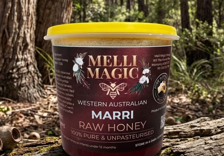 Melli Magic Western Australian Marri Raw Honey in a jar on a mossy log in a forest setting.