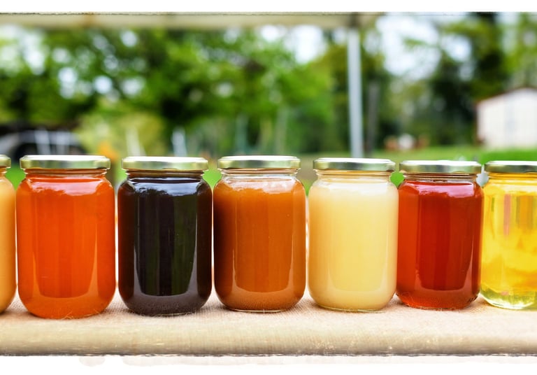 a row of jars of honeys and honeys