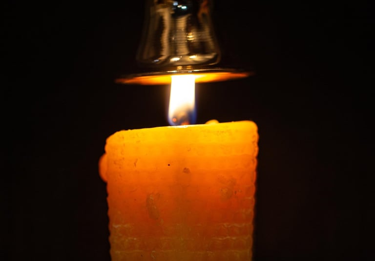 a candle with a candle lite up in the dark