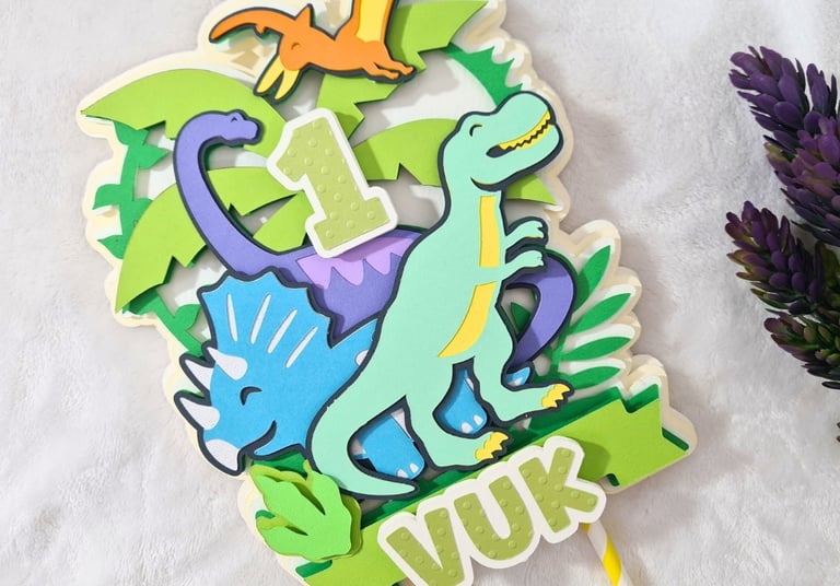 Cake topper with three dinosaurs. Vibrant.
