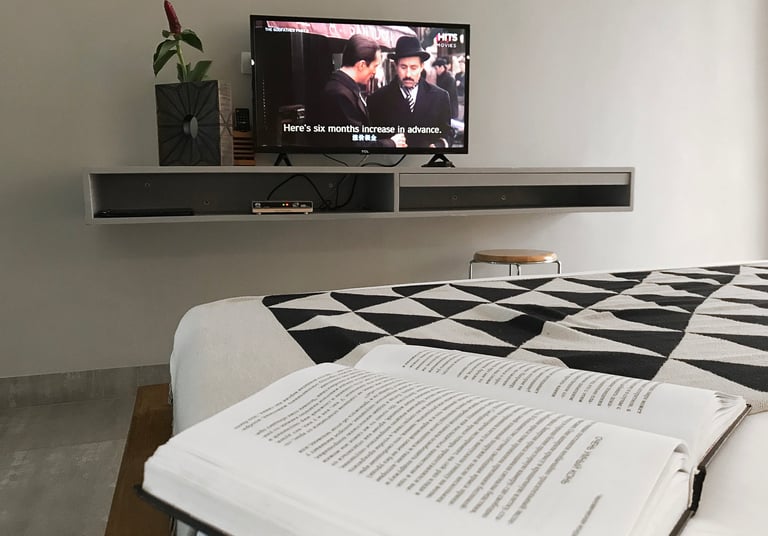 a book is sitting on a bed with a book and a book