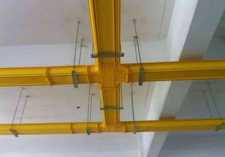 a ceiling with a yellow fiber cabler tray systems