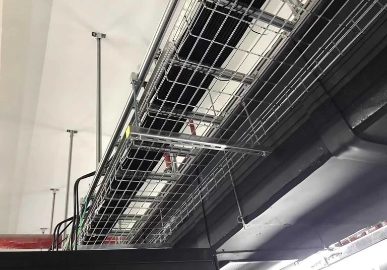 a metal wire mesh cable tray with bundles cables hanging in the ceiling