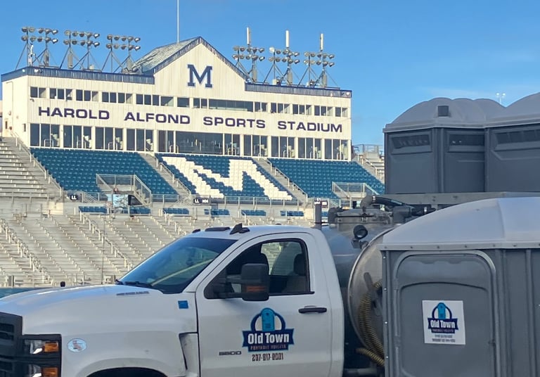 Truck at u of Maine with portable toilets