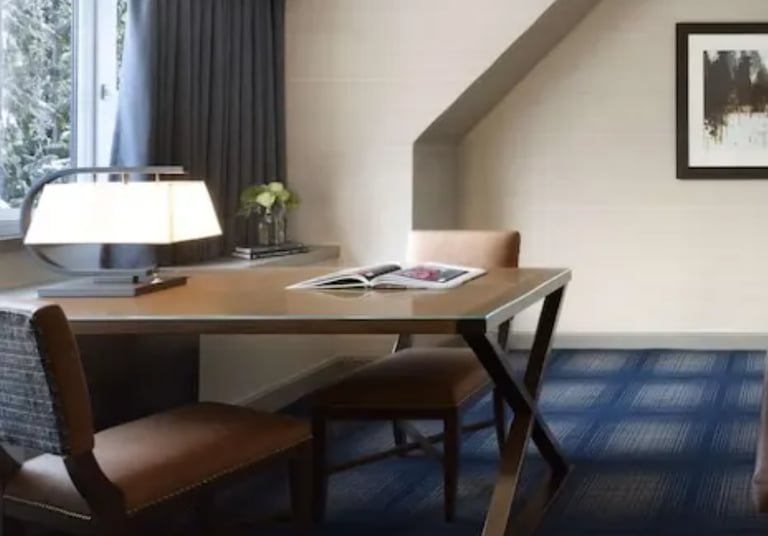 a hotel room with a bed and a desk