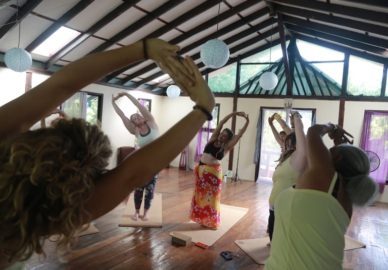 a group of people doing yoga exercises in a room
