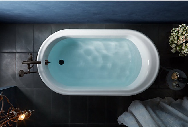 a bathtub with a blue skylight and a white bathtub