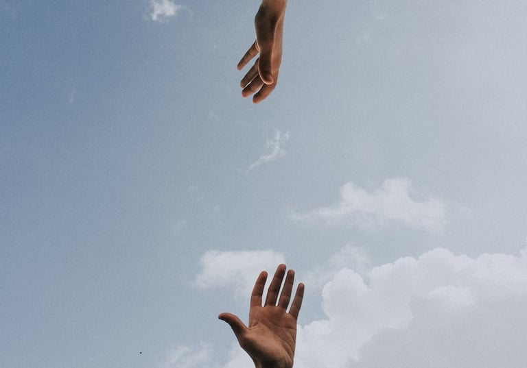 two hands reaching for collaboration