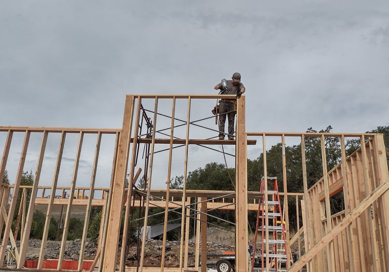 a man on a scaffolding on a construction site