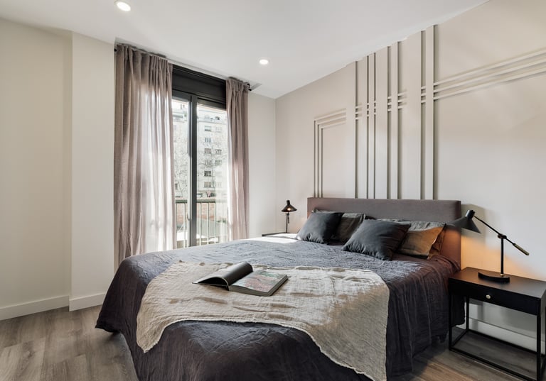 Elegant bedroom with wall panels, calm color palette and modern minimalist design in Barcelona