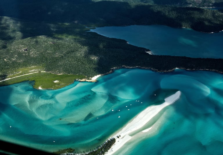 Aerial view of Hill Inlet and Whitehaven Beach with turquoise water and swirling white sand.