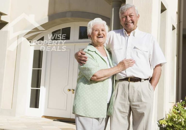 a man and woman standing in front of a house