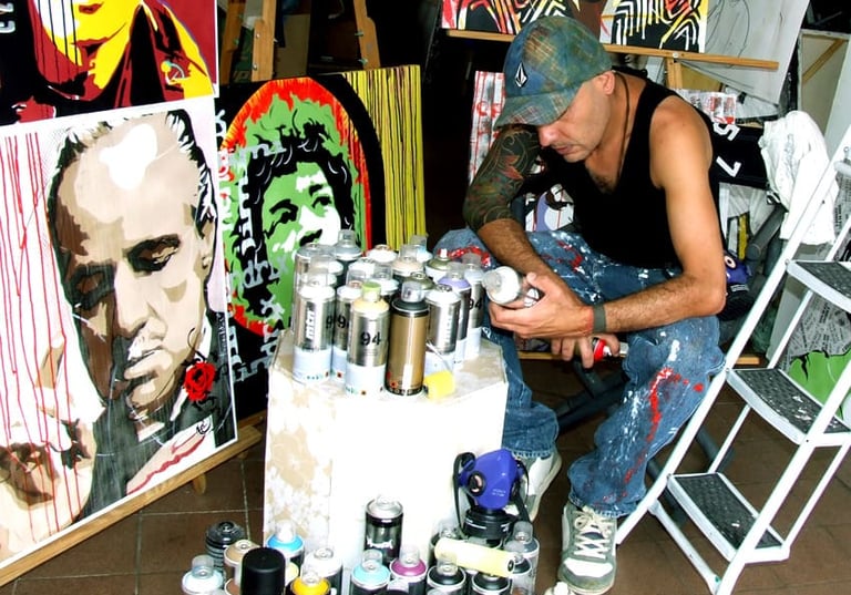 Sérgio Astral, em seu ateliê, com quadros em pop-art.