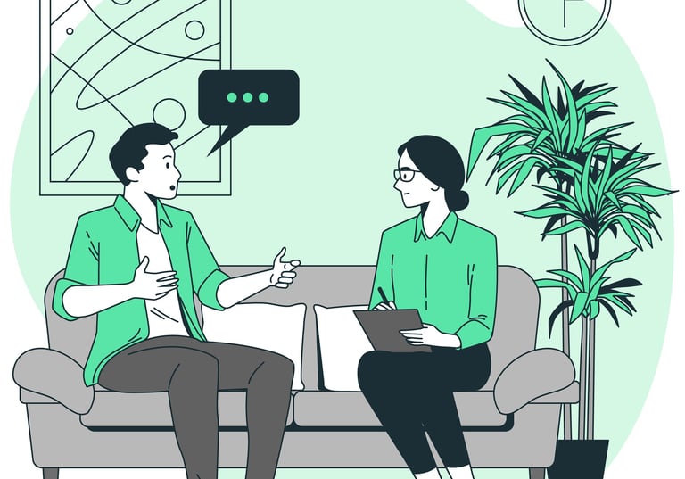 a man and woman sitting on a couch talking in a therapy session