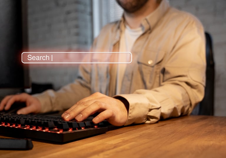 a man sitting at a desk with a keyboard and a keyboard