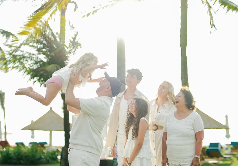 Family portrait captured during golden hour in the tropical gardens of Ayodya Resort Bali