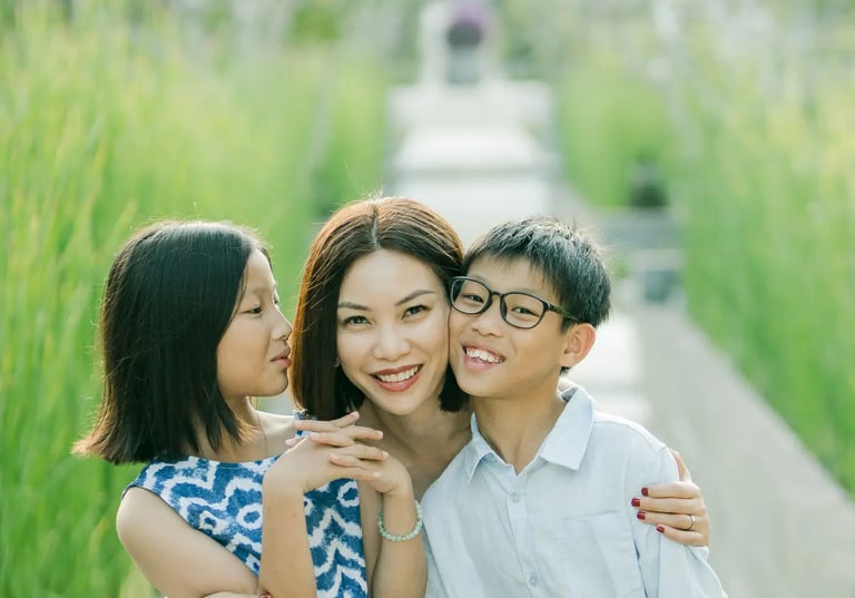 Brother and sister sharing a playful moment during a family photography session at The Ritz-Carlton Bali.