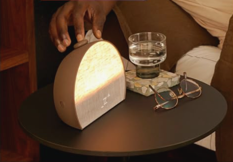 Hatch Restore 3 smart sunrise alarm clock in Putty fabric on a modern nightstand.