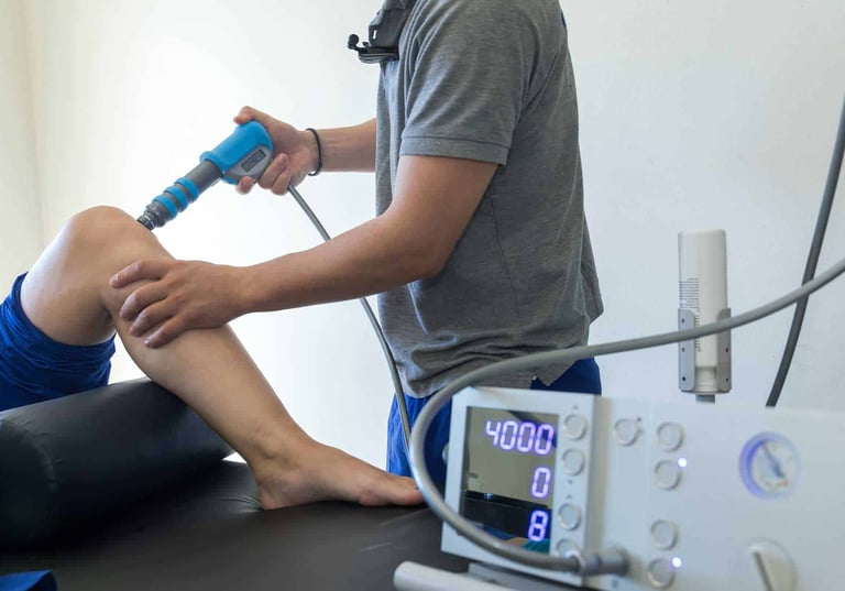 Physio doing shockwave on knee