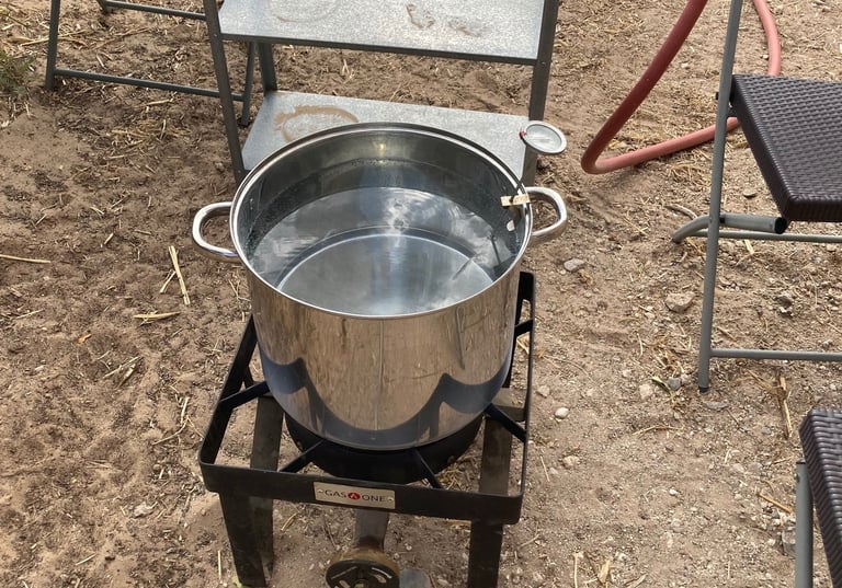 Outdoor propane burner used to heat water to wash wool.