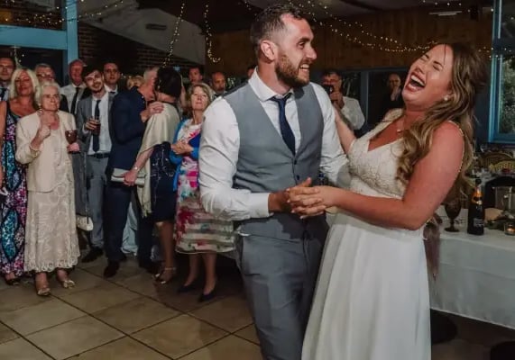 A bride and groom dancing to a high-energy live set from Mosaic wedding band