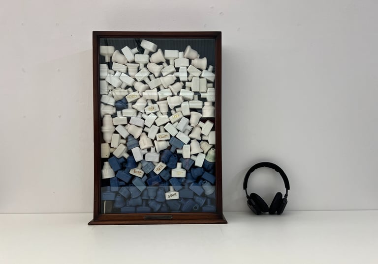 Public art installation, a cabinet filled with cast porcelain ceramic bottles and audio installation