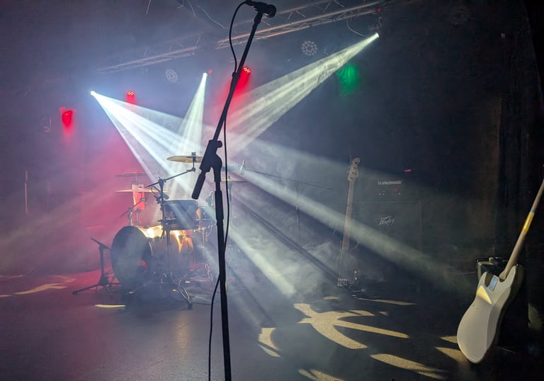 Professional stage lighting and PA setup for a Mosaic live performance at a marquee wedding