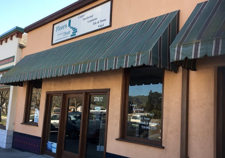 a building with a green awning and a sign that says,