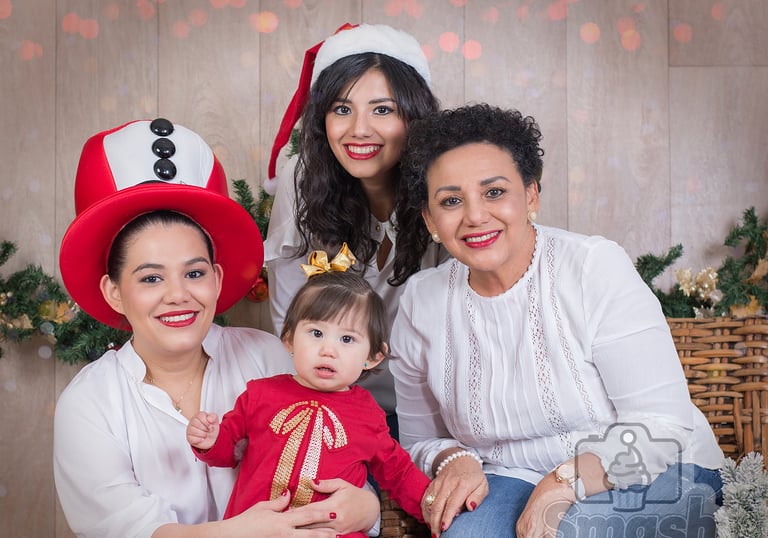 a family posing for a photo with a christmas tree