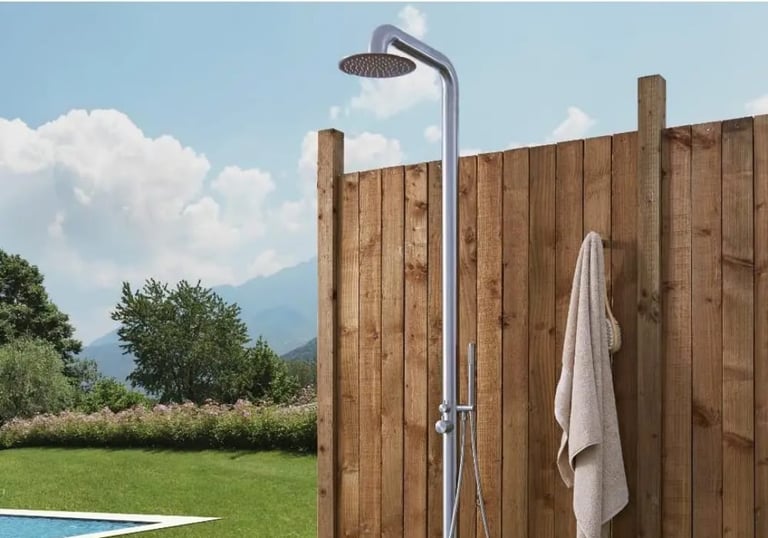 a shower with a shower head and a towel