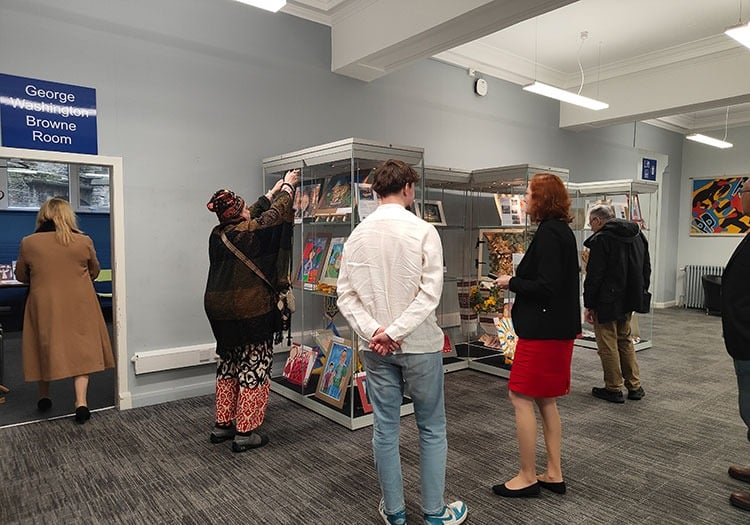 People looking at the display of Ukrainian children's paintings