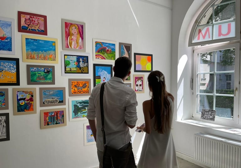 People admiring paintings made by children affected by war in Vienna
