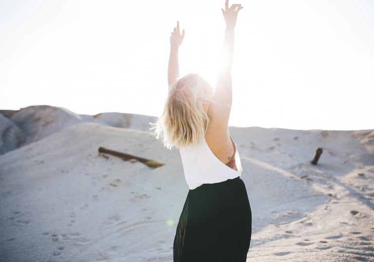 Embracing freedom as golden light shines upon her, symbolizing liberation & choosing authentic life