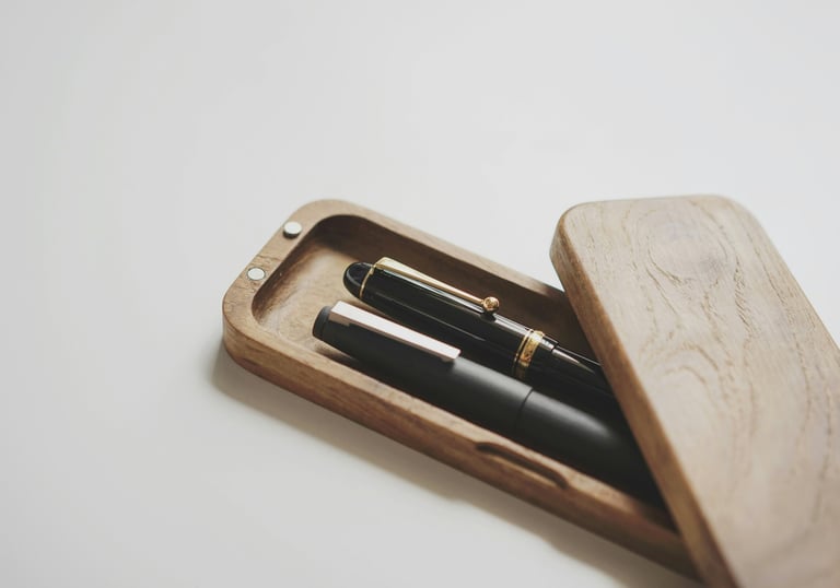 Wooden box holding two cherished pens representing the essence of living with what is meaningful