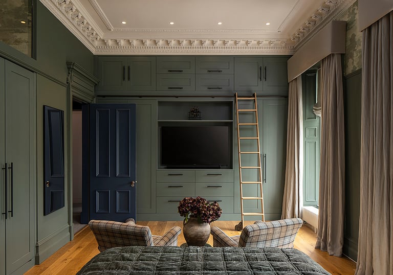 a bedroom with a ladder to climb up to the bed