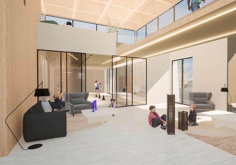 espace détente et jeux avec des canapés et la salle de sport au fond