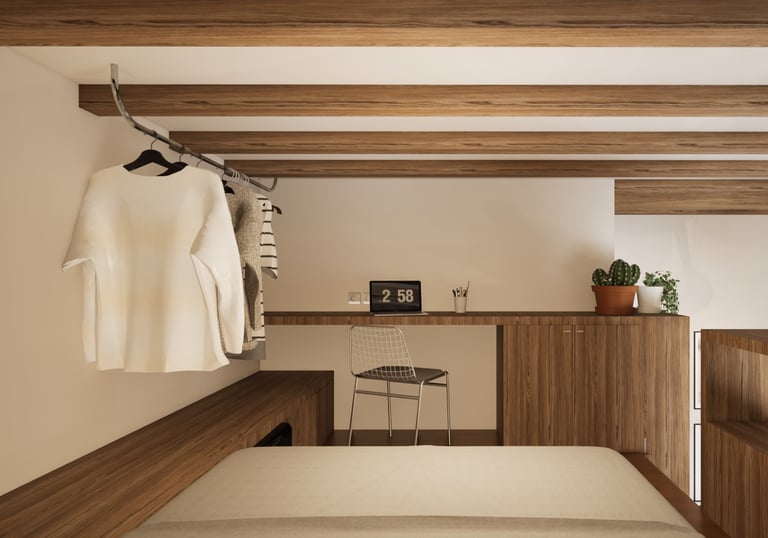 Chambre sur la mezzanine, avec vue sur un bureau et une penderie ouverte
