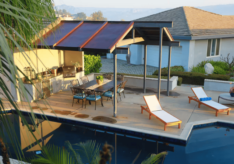 a pool with lounge chairs and a patio table