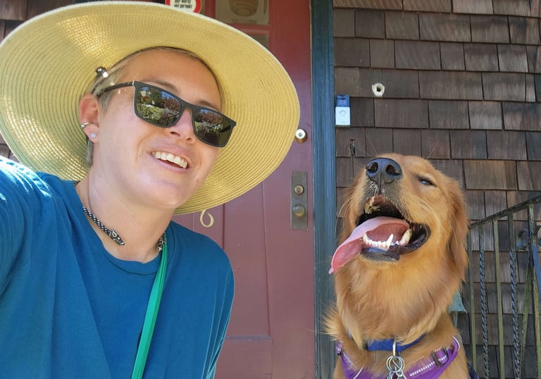 A golden retriever and a person take a selfie