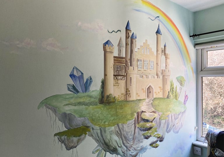Kid's mural of a magical castle with crystals, a rainbow and white clouds
