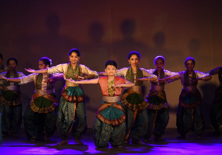 The batch of bharatanatyam performing on stage by Kalpangan Sanskrutik Kendra