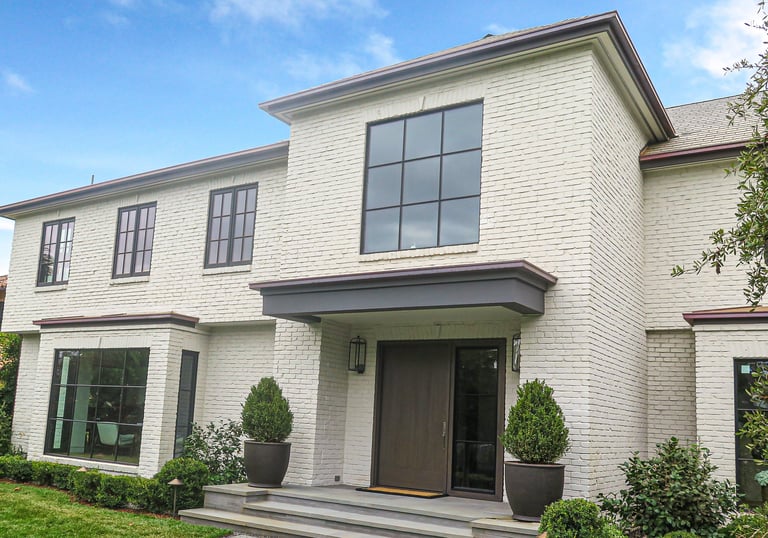 a white house with a large front door and a large front door