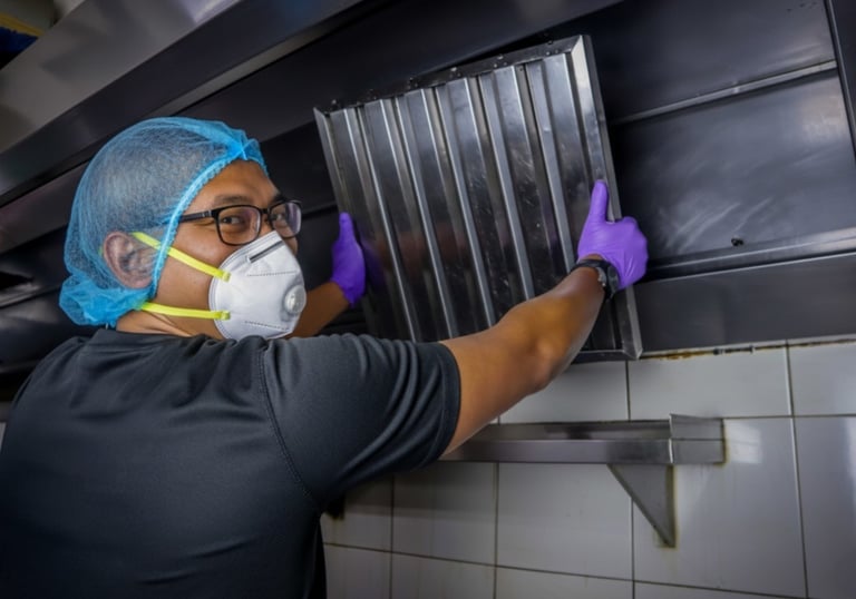 a person installing a hood filter